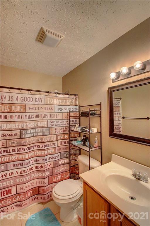 49 Sovereign Circle Clyde, NC 28721 - Photo 16 of 23 a bathroom with a sink toilet and shower