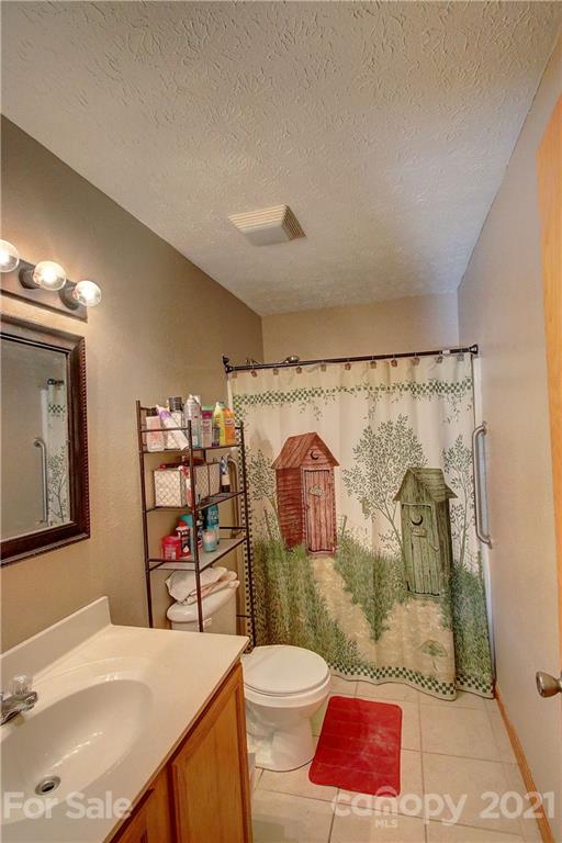 49 Sovereign Circle Clyde, NC 28721 - Photo 18 of 23 a bathroom with a sink toilet and shower
