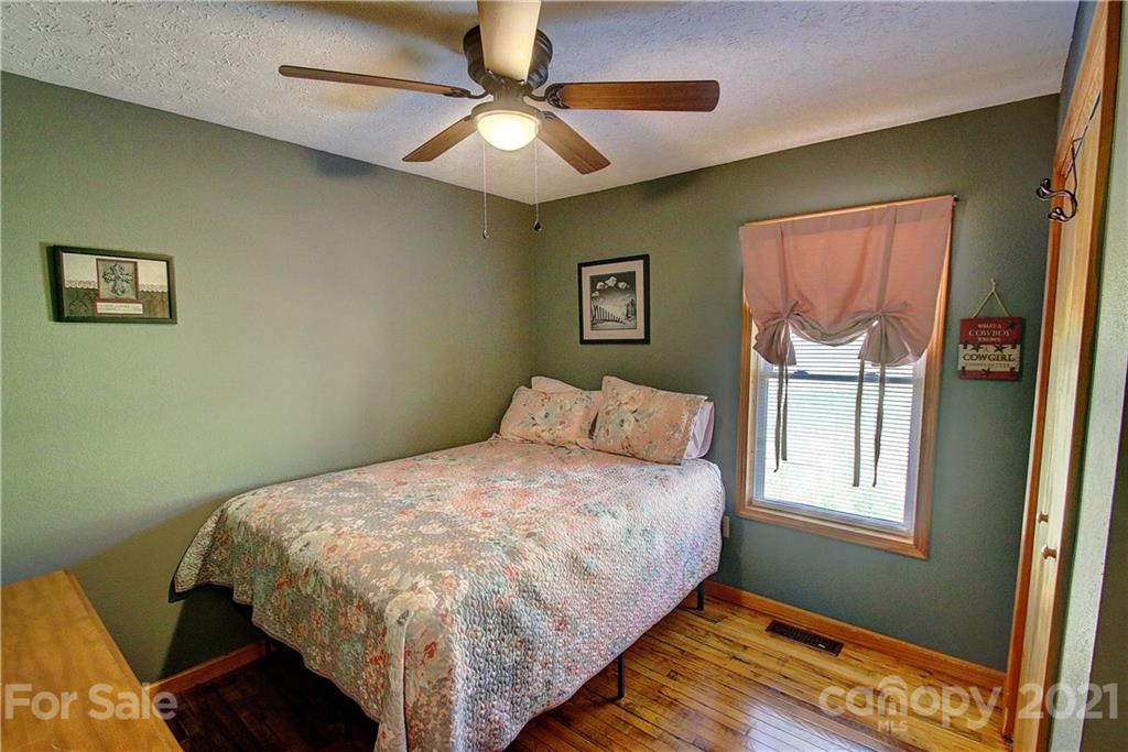 49 Sovereign Circle Clyde, NC 28721 - Photo 19 of 23 a bed sitting in a bedroom next to a window