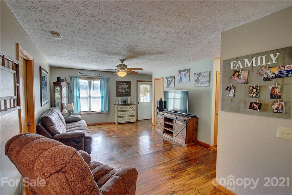 49 Sovereign Circle Clyde, NC 28721 - Photo 8 of 23 a living room with furniture and a flat screen tv