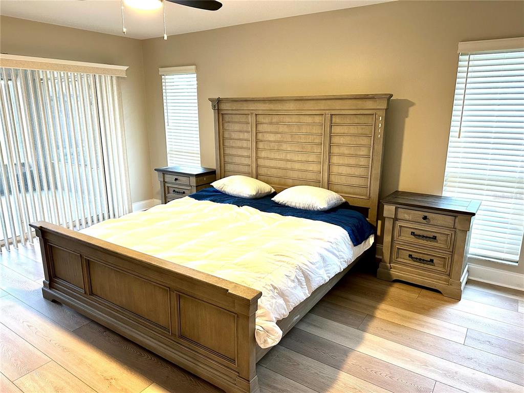 11735 Southeast 174th Loop Summerfield, FL 34491 - Photo 12 of 19 a bedroom with a bed and a night stand
