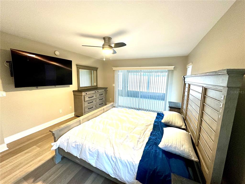 11735 Southeast 174th Loop Summerfield, FL 34491 - Photo 13 of 19 a bed room with a bed a television and a large window