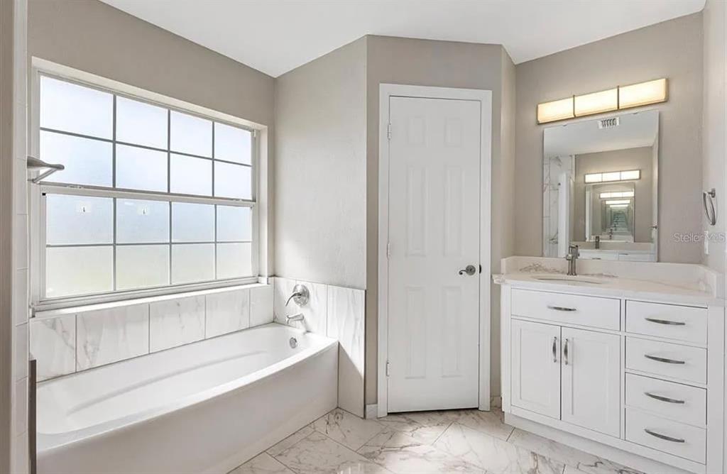 11735 Southeast 174th Loop Summerfield, FL 34491 - Photo 15 of 19 a spacious bathroom with a tub shower and sink