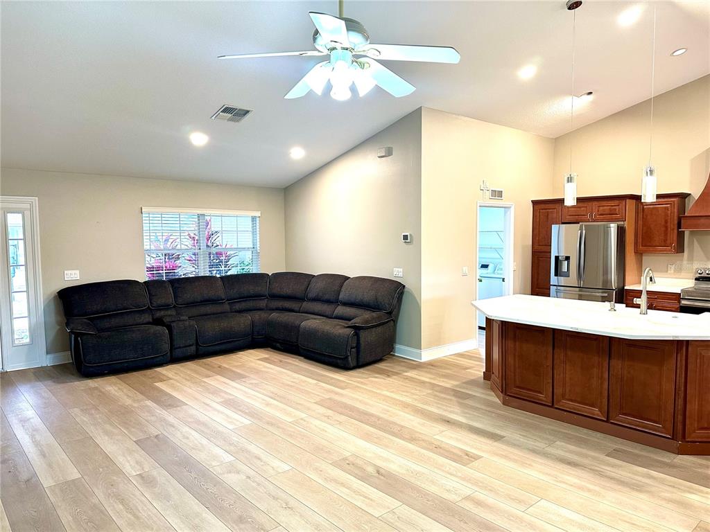 11735 Southeast 174th Loop Summerfield, FL 34491 - Photo 9 of 19 a living room with furniture and a chandelier