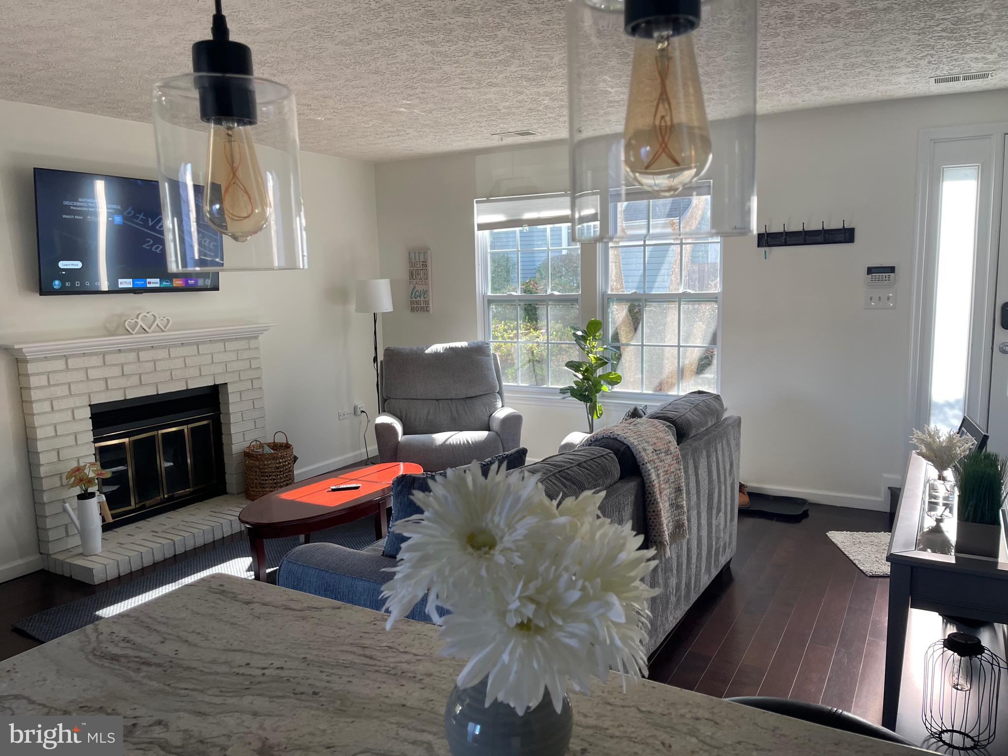 2960 McGee Way Olney, MD 20832 - Photo 2 of 25 a living room with furniture fireplace and flat screen tv