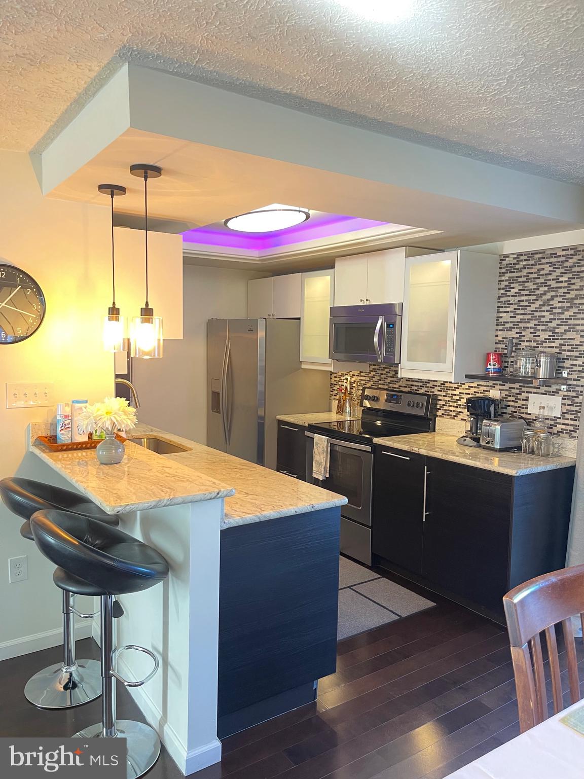 2960 McGee Way Olney, MD 20832 - Photo 6 of 25 a kitchen with a sink cabinets and wooden floor