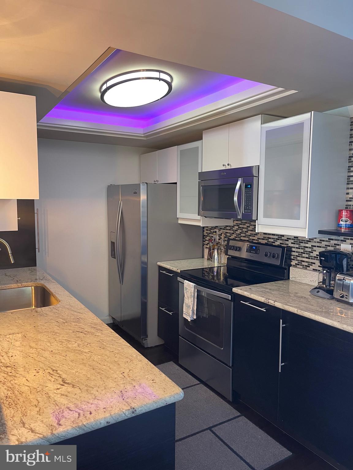 2960 McGee Way Olney, MD 20832 - Photo 7 of 25 a kitchen with stainless steel appliances granite countertop a sink and wooden cabinets