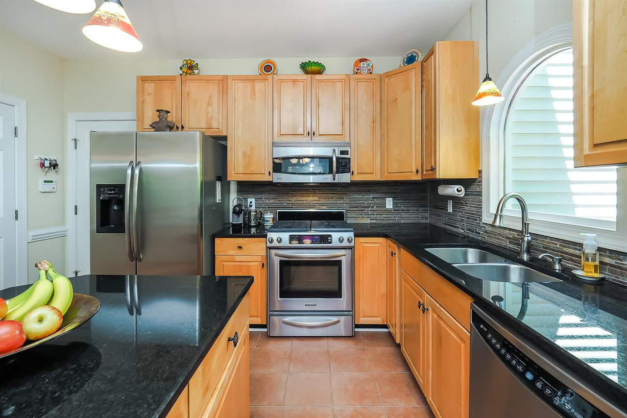 3309 Byers Drive Raleigh, NC 27607 - Photo 5 of 25 Solid surface counters, island and gas stove. Refrigerator conveys with the home. Kitchen