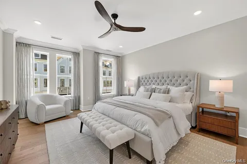 a bedroom with a bed a couch and a window