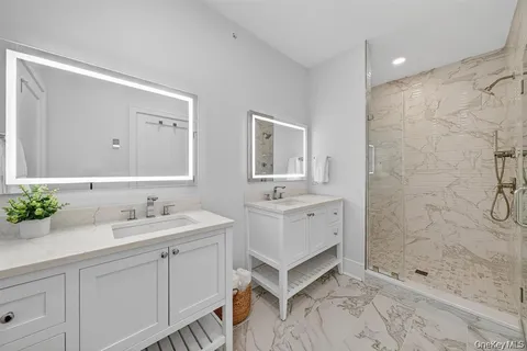 a spacious bathroom with double sink and a mirror