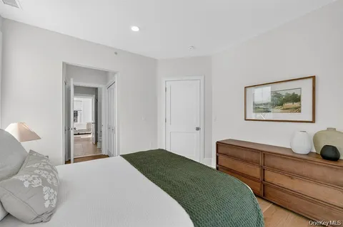 a bedroom with bed and a chandelier