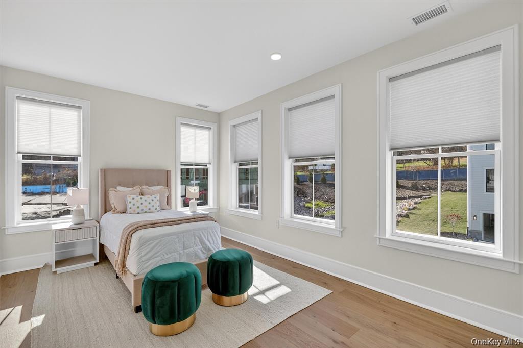 1822 Soundview Court Yorktown Heights, NY 10598 - Photo 30 of 39 a bedroom with a bed and wooden floor