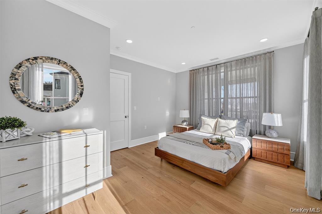 1822 Soundview Court Yorktown Heights, NY 10598 - Photo 6 of 39 a bedroom with a bed a mirror and a potted plant