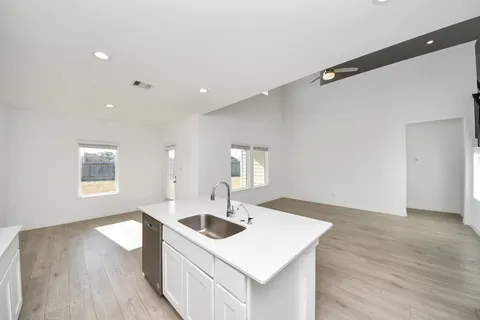 a kitchen with stainless steel appliances granite countertop a stove a refrigerator and a more cabinets