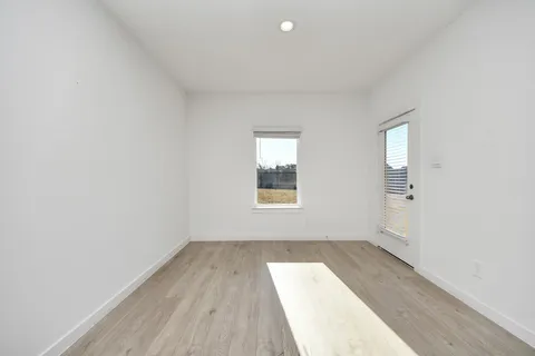 a view of a dining room with furniture a livingroom and chandelier