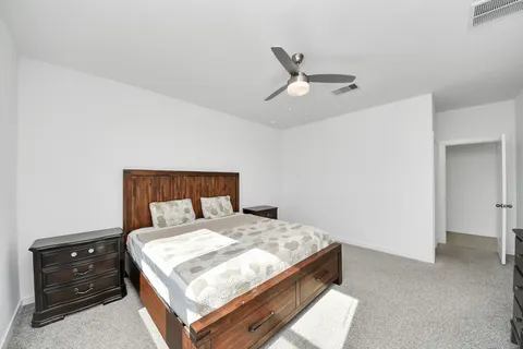 a bed sitting in a bedroom next to a window