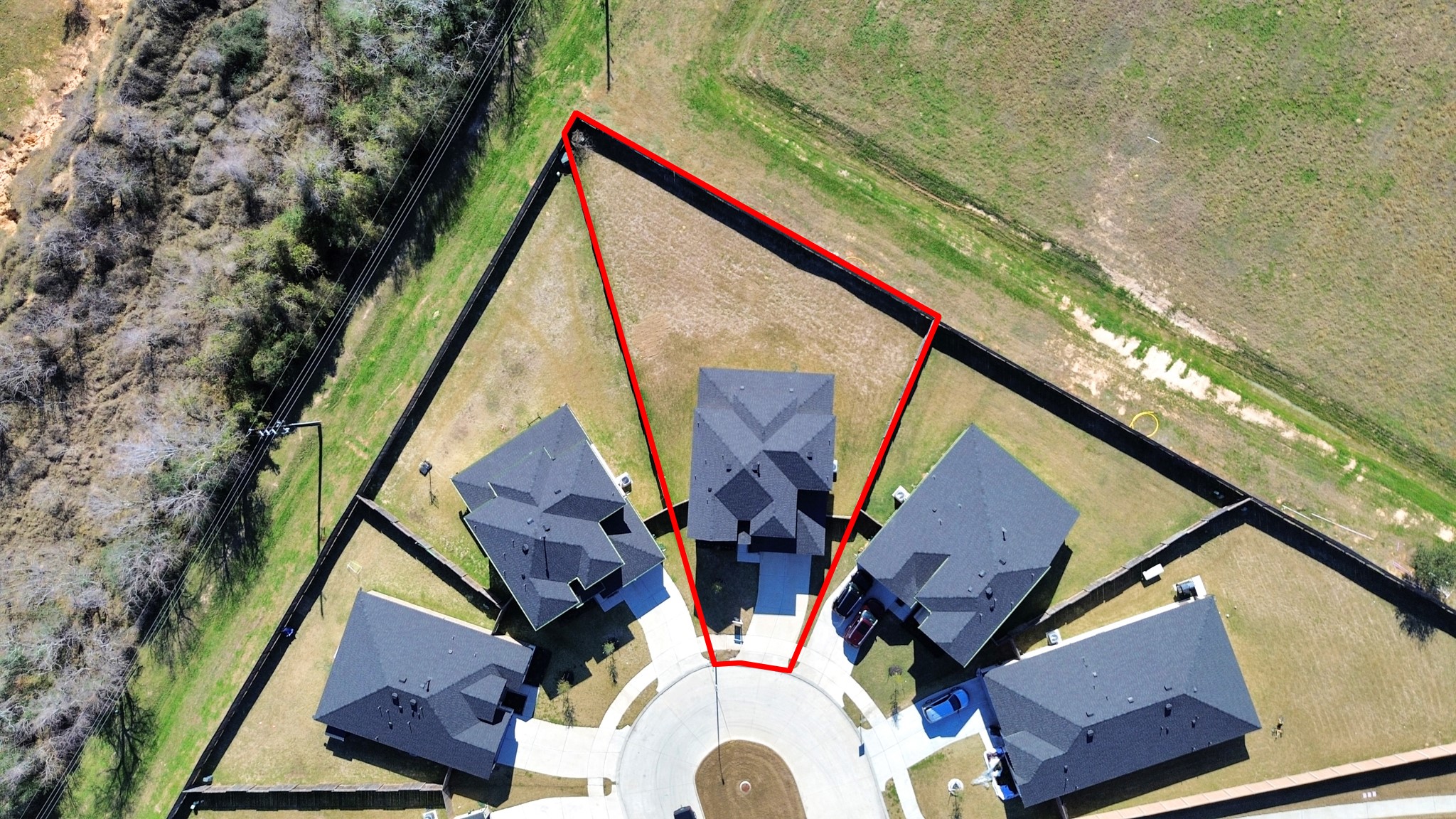 28603 Crowley Court Katy, TX 77494 - Photo 2 of 50 This house sits on a cul-de-sac with a triangular lot, outlined in red. The property has no back neighbors, with a mix of open and wooded areas nearby, providing a blend of community and natural surroundings.