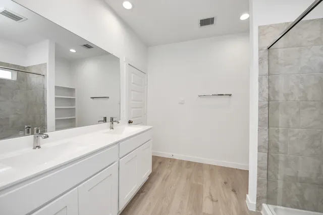 a bathroom with a double vanity sink a and a