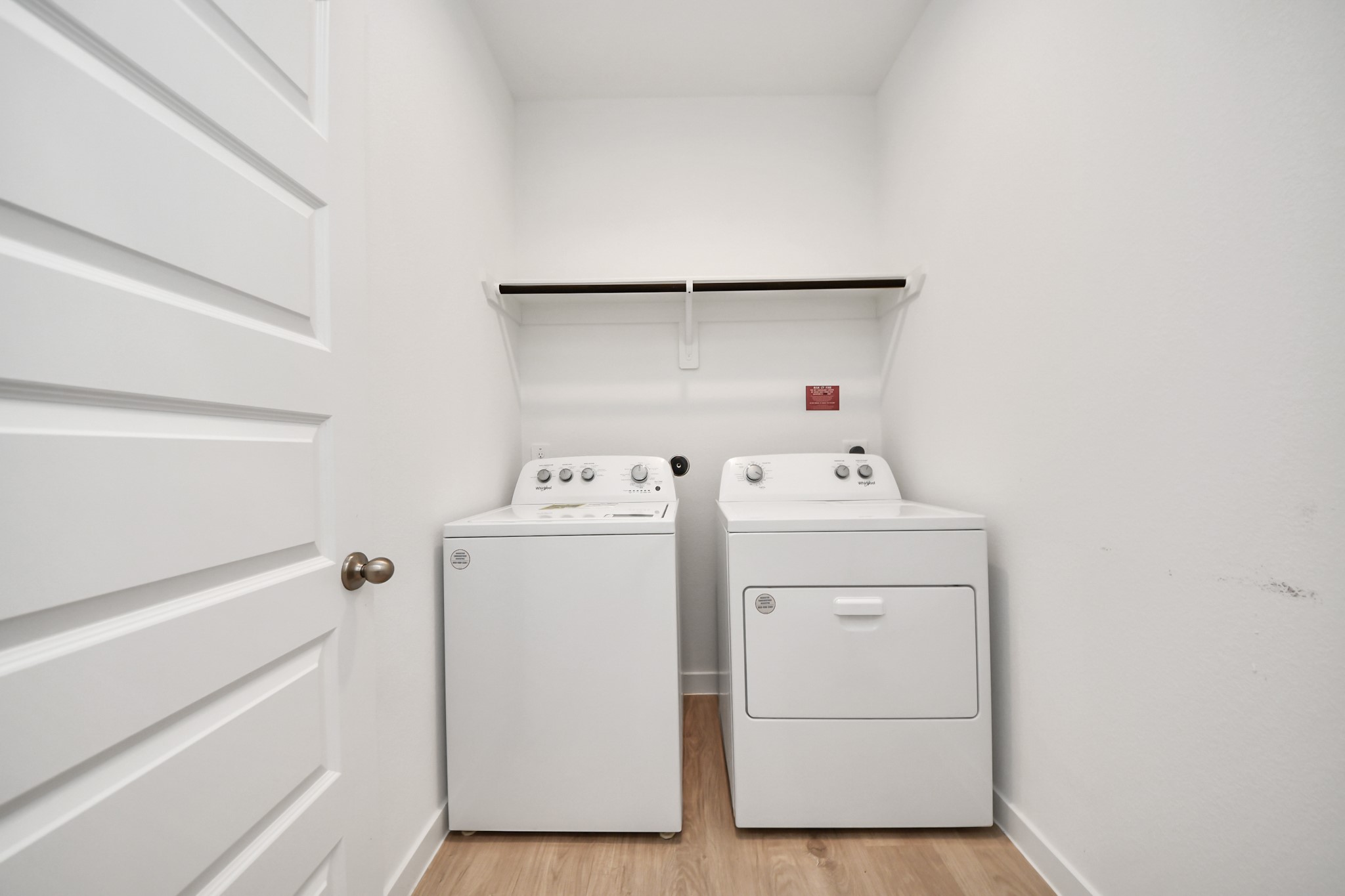 28603 Crowley Court Katy, TX 77494 - Photo 41 of 50 A laundry room with a washer and dryer side by side. There's also shelf above for storage.