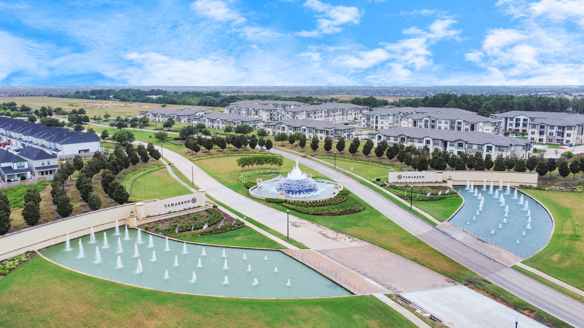 28603 Crowley Court Katy, TX 77494 - Photo 47 of 50 A well-planned residential community featuring modern homes, landscaped greenery, and an inviting entrance with fountains. The area offers a spacious and serene environment, ideal for the new homeowner.