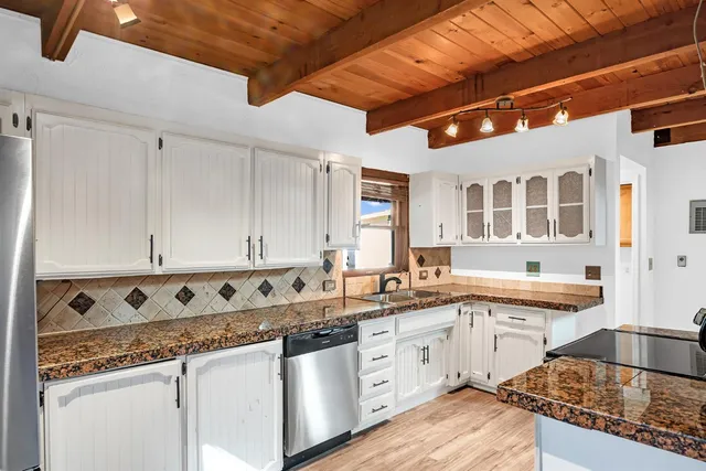 a kitchen with stainless steel appliances granite countertop a sink stove and cabinets