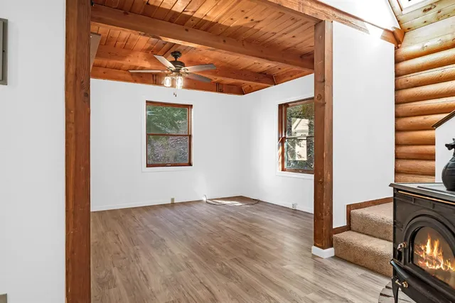 a view of a livingroom with wooden floor and windows