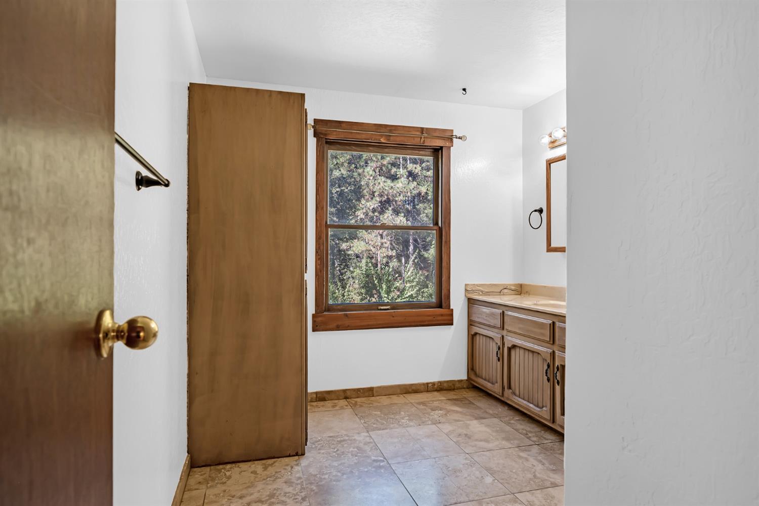 1610 Swansboro Road Placerville, CA 95667 - Photo 23 of 50 a view of an empty room with a fireplace and a window
