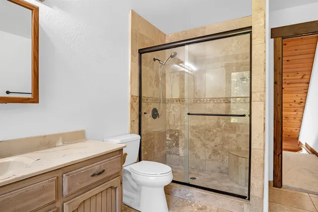 a bathroom with a shower toilet and sink