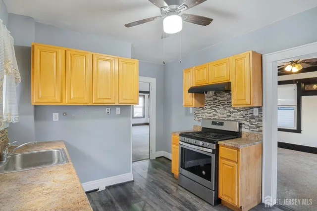 a kitchen with stainless steel appliances granite countertop a stove and a sink
