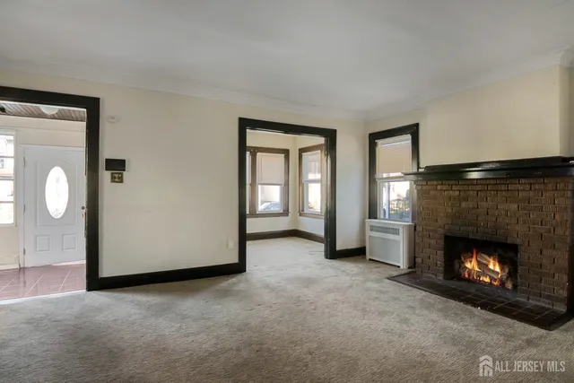 a view of a livingroom with a fireplace and window