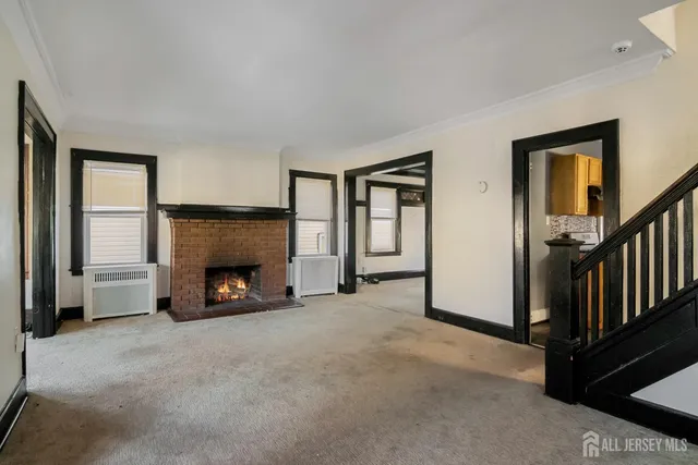 a view of a livingroom with a fireplace and a window