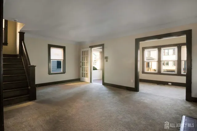 a view of an empty room with a fireplace and a window