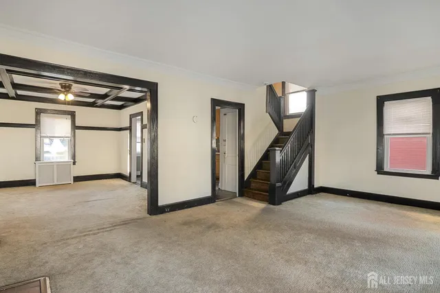 a view of an empty room with a fireplace and a window