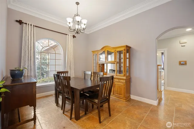 a view of a dining room with furniture a chandelier and wooden floor
