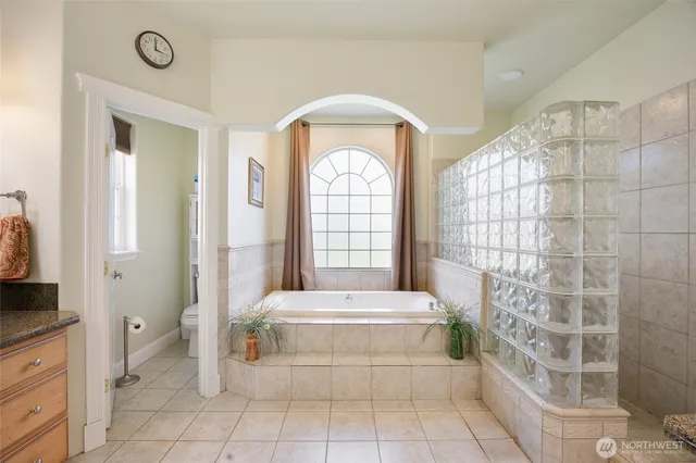 a spacious bedroom with a bed and a window