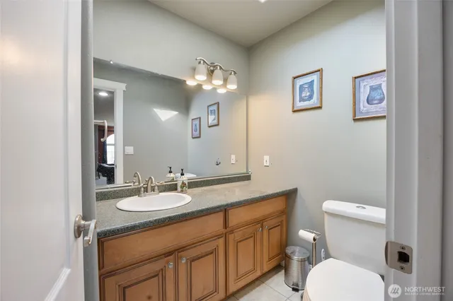 a bathroom with a toilet a sink and mirror