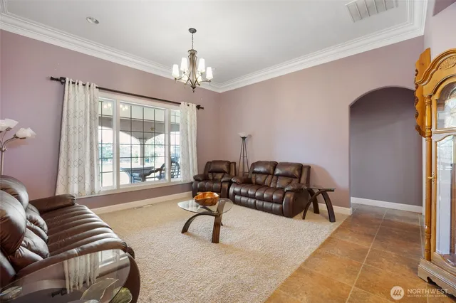 a living room with furniture and a chandelier