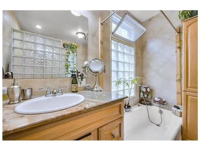 a bathroom with a sink mirror and vanity