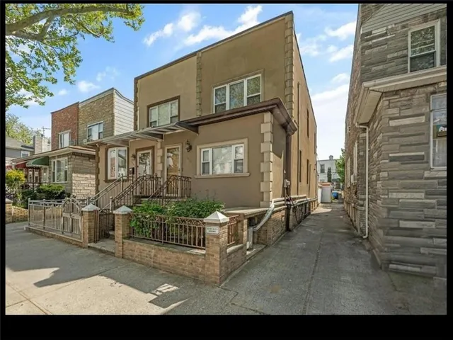 a view of a brick house with many windows
