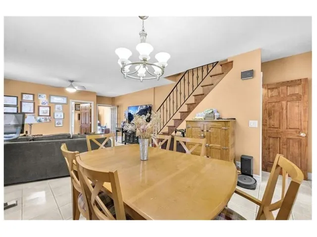 a view of a dining room with furniture and a chandelier