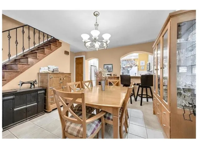 a view of a dining room with furniture and a chandelier