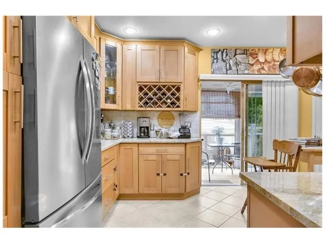 a kitchen with granite countertop a refrigerator and a stove