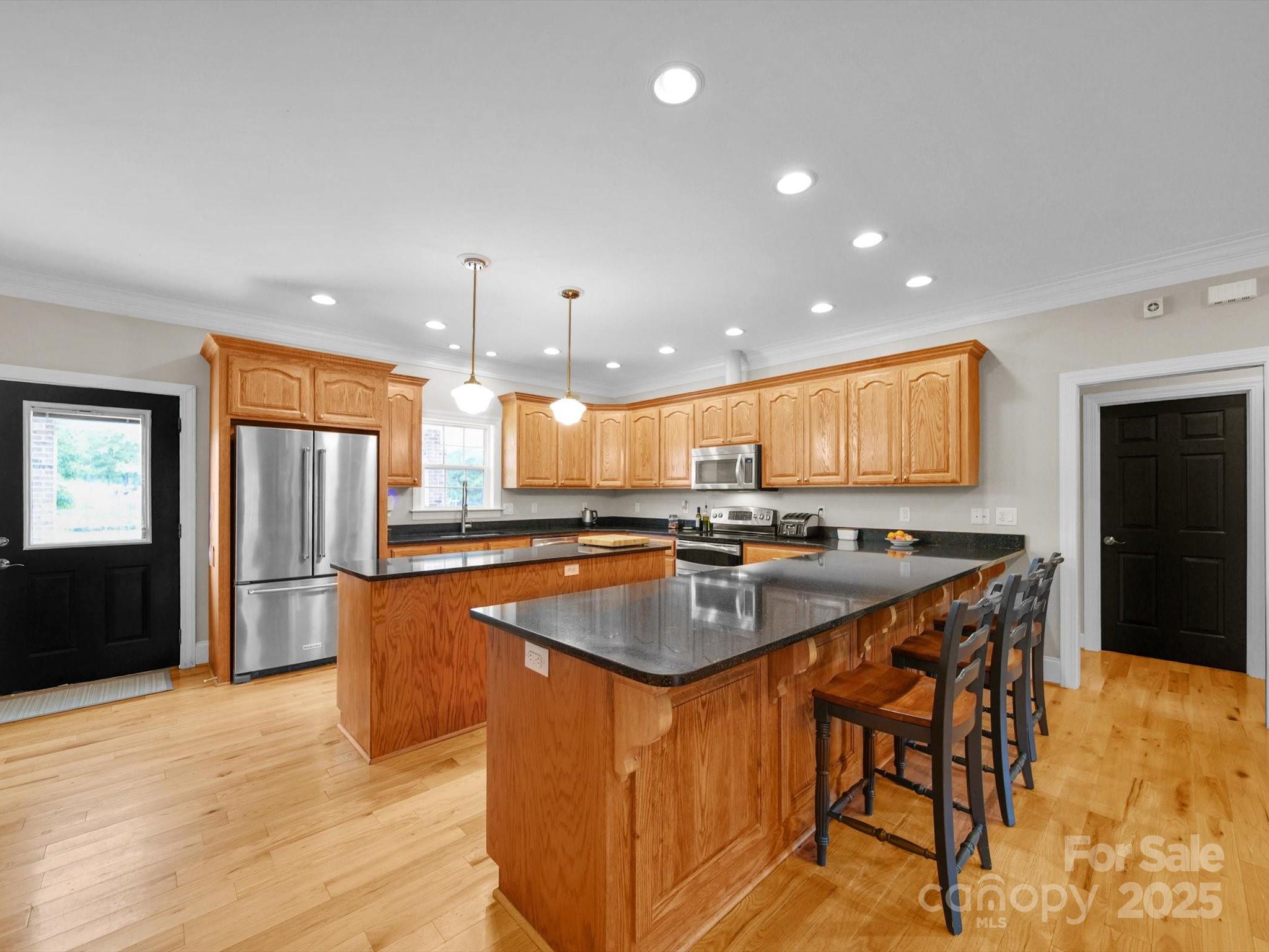 1393 Wateree Road Ridgeway, SC 29130 - Photo 11 of 42 a kitchen with stainless steel appliances granite countertop a sink a stove and a refrigerator