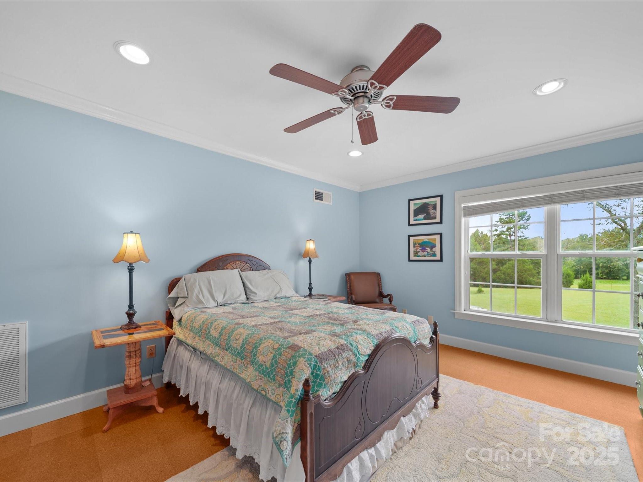 1393 Wateree Road Ridgeway, SC 29130 - Photo 28 of 42 a bedroom with a bed a window and a chandelier