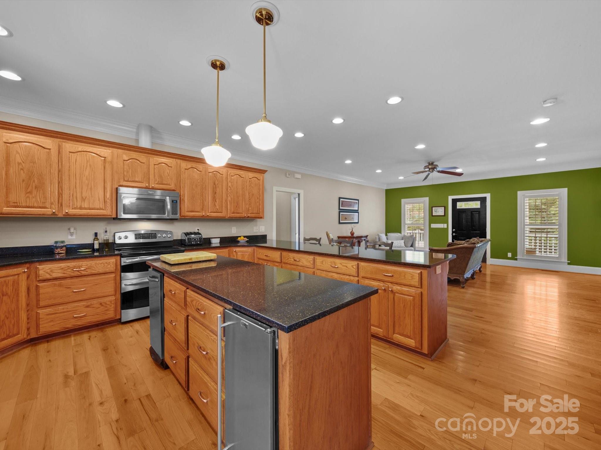 1393 Wateree Road Ridgeway, SC 29130 - Photo 9 of 42 a kitchen with stainless steel appliances granite countertop wooden cabinets a stove top oven a sink and dishwasher a oven with wooden floor