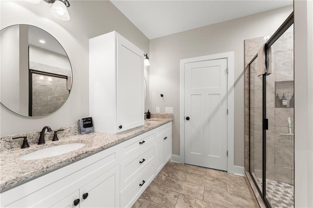 1320 Preacher Campbell Road Clarkesville, GA 30523 - Photo 16 of 36 a bathroom with a granite countertop double vanity sink mirror and
