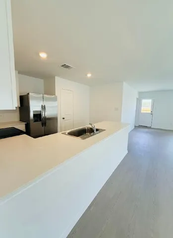 a large room with a bed and large windows