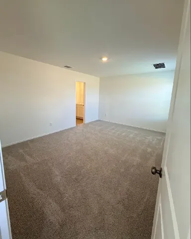 a view of an empty room and a window