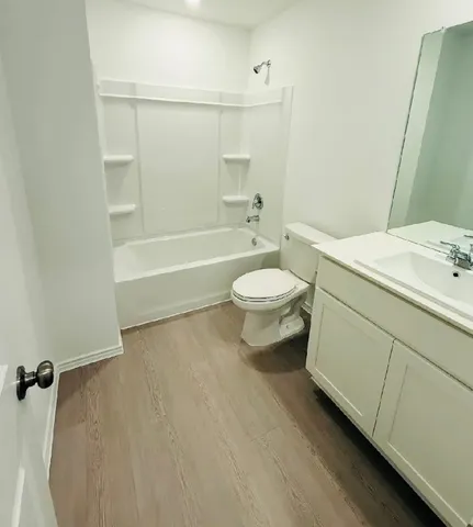 a bathroom with a toilet a sink and bathtub