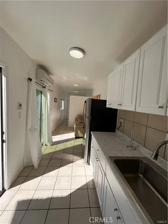 a kitchen with a sink a stove and refrigerator